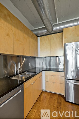 A kitchen with wooden cabinets and stainless steel appliances.