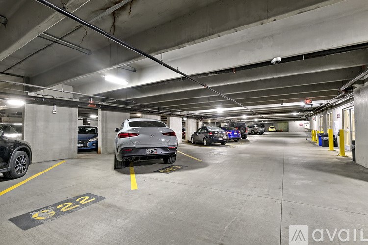 A parking garage with cars parked and a sign that says "available".