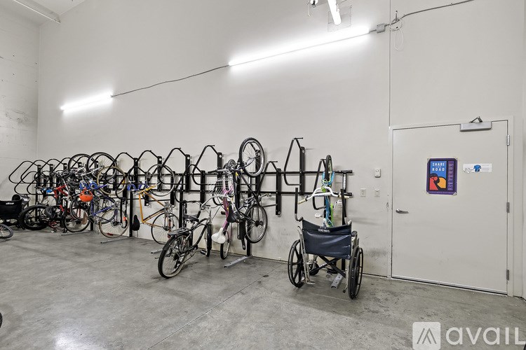 A room full of bicycles and a wheelchair.
