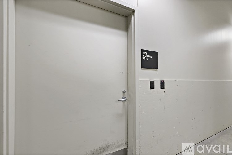 A white door with a sign that says "Bike Storage Only" on the wall.