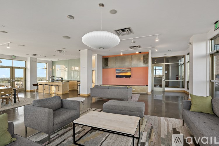 A modern living room with a grey sofa set and a wooden coffee table.