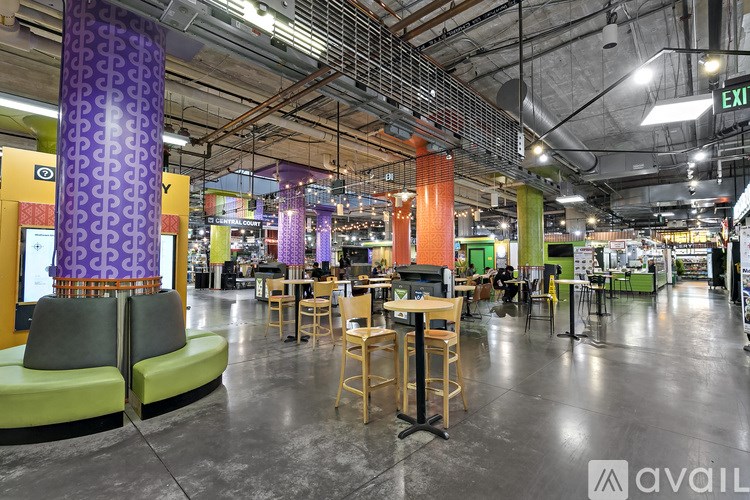 A large open space with tables and chairs and a purple column.