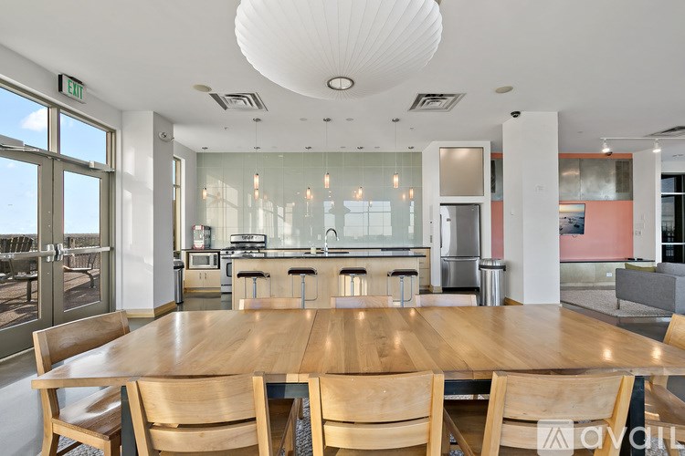 A modern dining room with a wooden table and chairs.