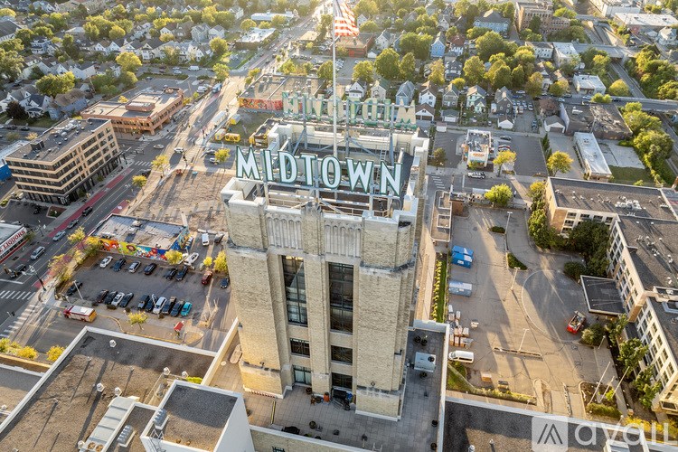 An aerial view of a parking lot and a building with a sign that says "Midtown".