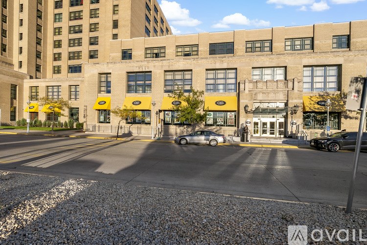 A street view of a building with a yellow awning.