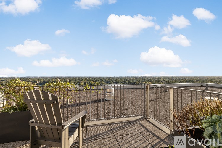 A balcony with a chair and a view of the city.