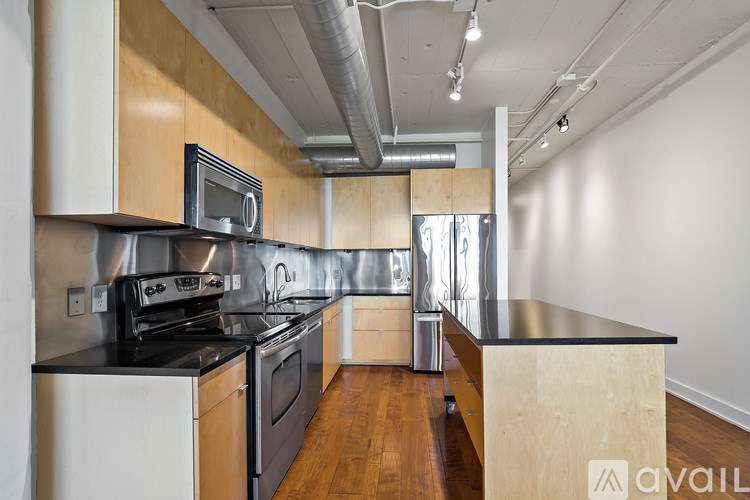 A kitchen with wooden cabinets and stainless steel appliances.