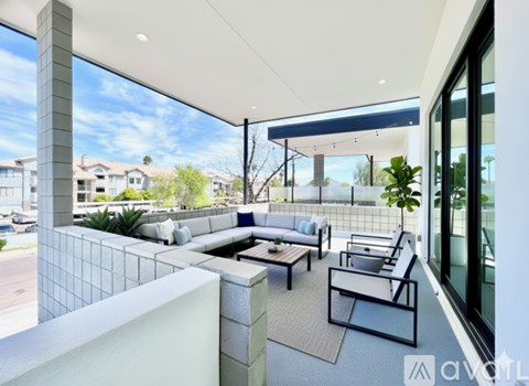 A modern outdoor living space with a view of the neighborhood.