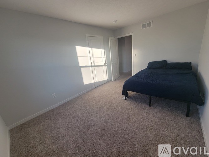 A bedroom with a bed, dresser, and mirror.