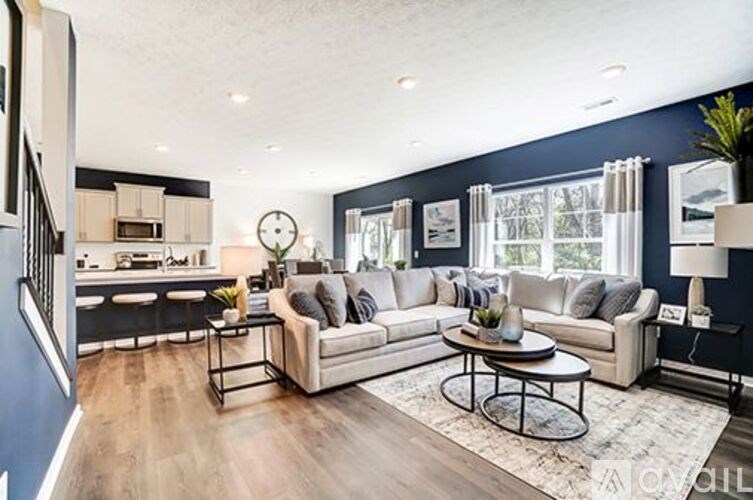 A modern living room with a large sectional sofa and a coffee table.