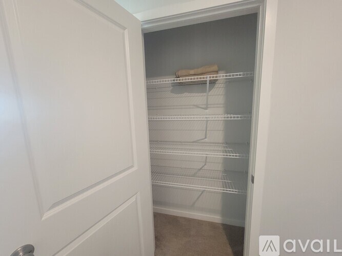 A room with a sofa, a TV, a bicycle, and a painting.