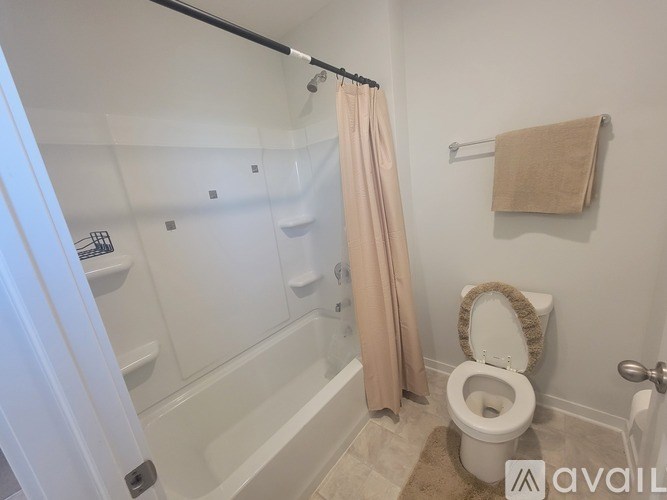 A bedroom with a large bed and a wooden dresser.