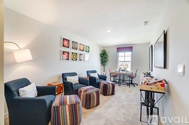 A living room with a sofa, chairs, and a table.