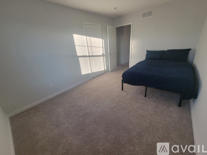 A modern dining room with a dark wood table and chairs.