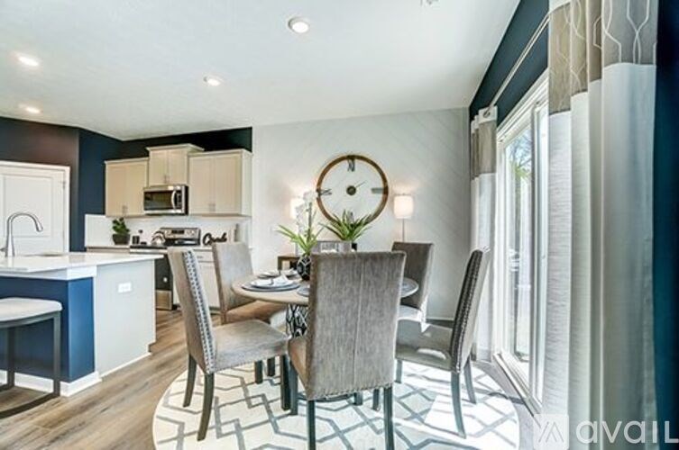 A modern kitchen with a dining table set for four.
