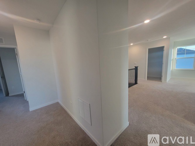 A kitchen with a stove, sink, and a dining table.