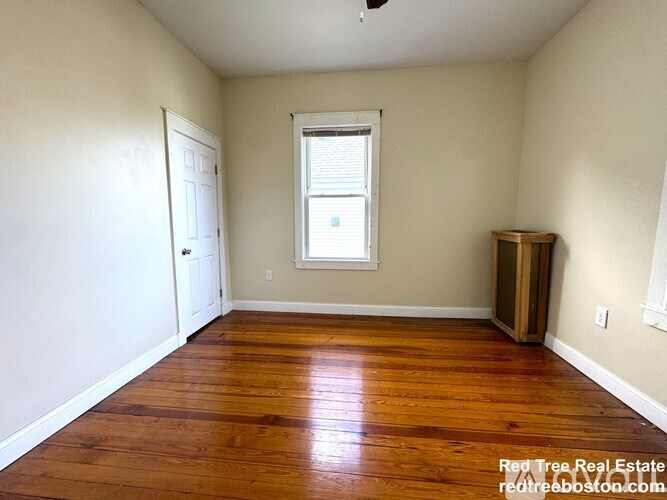 A room with wooden floors and a window.