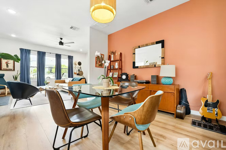 A living room with a dining table and chairs.