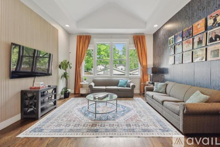 A living room with a couch, a coffee table, and a television.