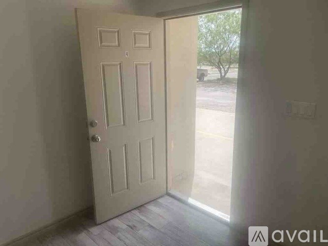 A white door is open to a hallway.