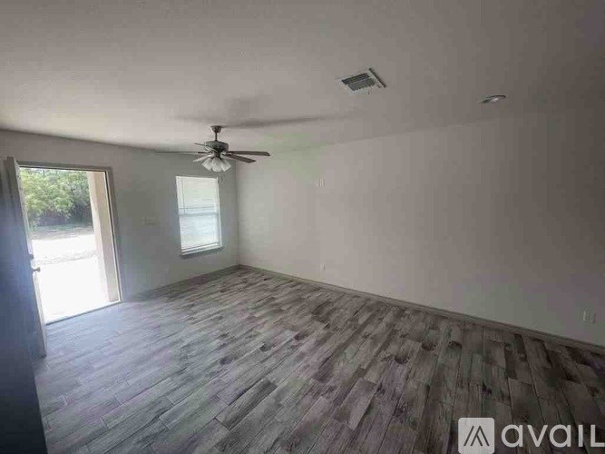 A room with a ceiling fan and wooden flooring is available for rent.