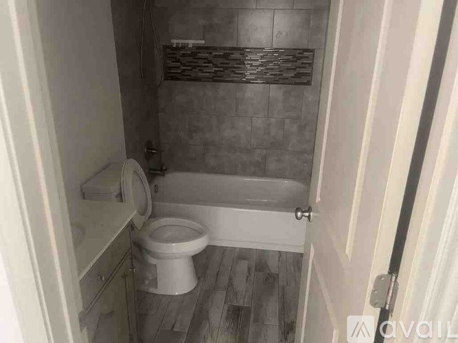 A small bathroom with a toilet, sink, and bathtub.