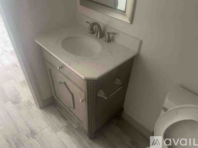 A bathroom sink with a mirror above it.