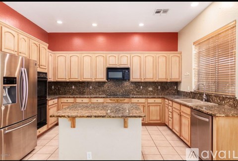 A kitchen with wooden cabinets and a granite countertop.