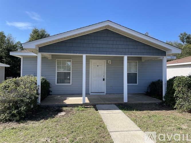 A small house with a front porch and a white door.