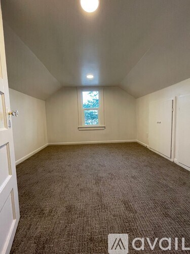 A room with carpeted floor and a window.