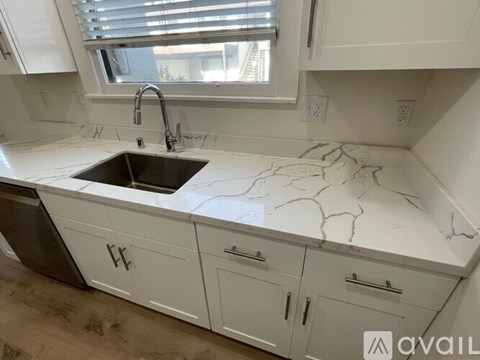 A kitchen with a sink and cabinets.