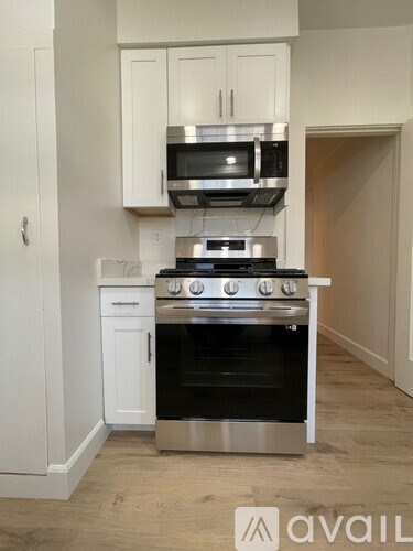 A kitchen with a stove top oven and microwave above it.