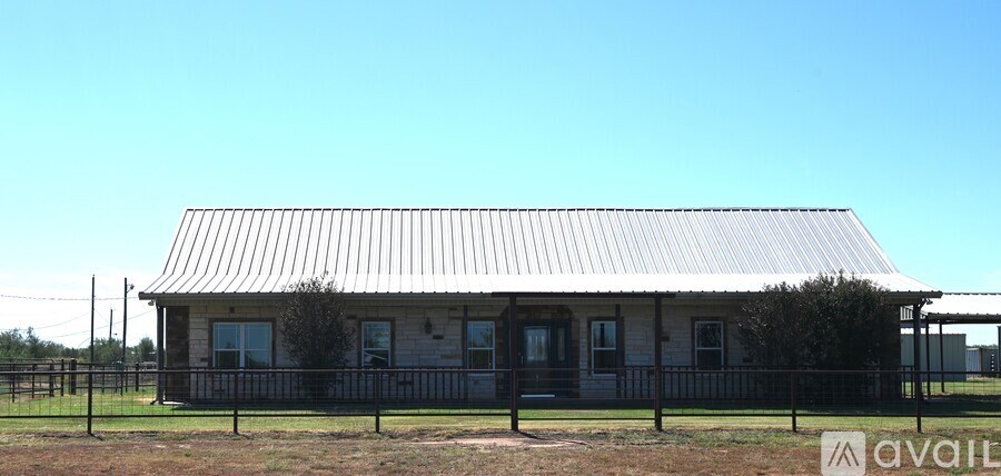 A house with a metal roof is for sale.