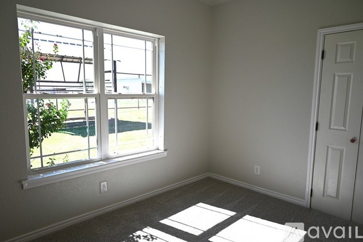 A room with a large window and a door.