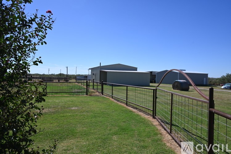 A fenced yard with a building in the background.