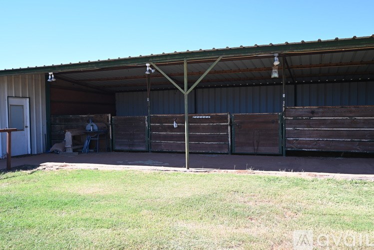 A large building with a metal roof and wooden walls.
