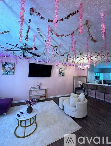 A living room with a white couch, a coffee table, and a ceiling fan.