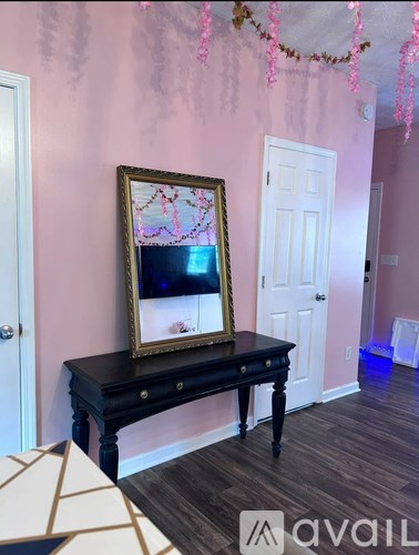 A black table with a framed picture on it in a room.