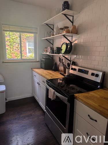 A kitchen with a white oven and black stove top.