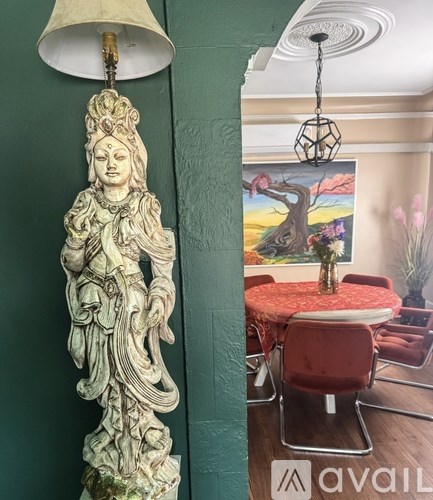 A room with a green wall and a white lamp.