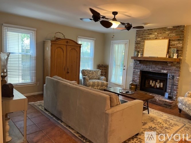 A living room with a fireplace and a couch.