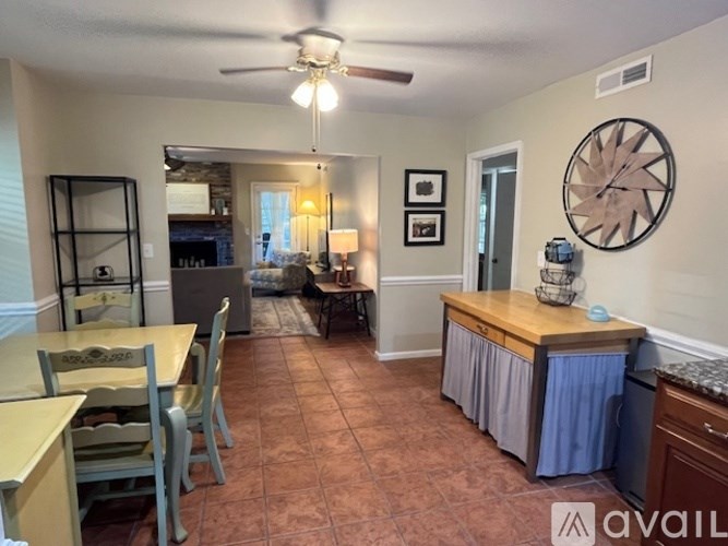 A living room with a dining table and chairs.