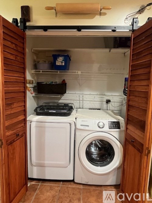 A small laundry room with a washer and dryer.