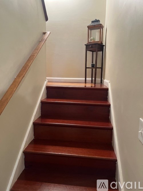 A wooden staircase with a lantern on top.