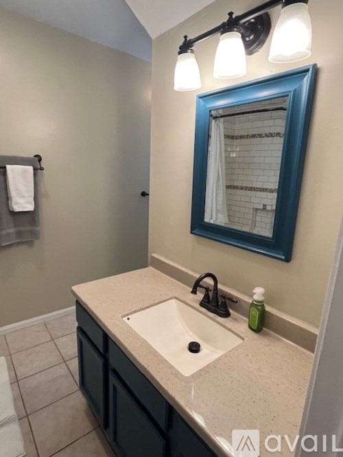 A bathroom with a sink and a mirror.