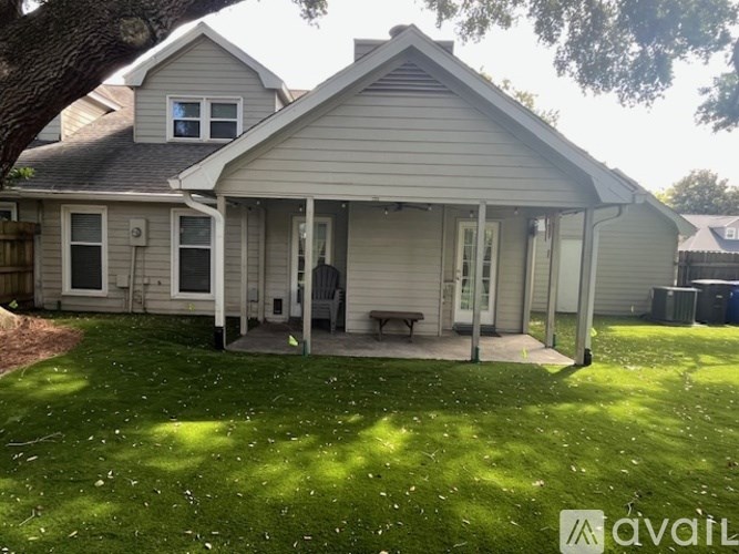 A house with a grey roof and a white door is for sale.