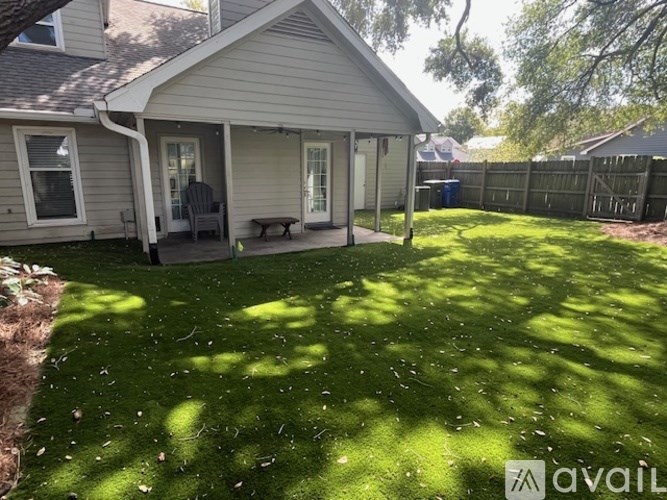 A backyard with a lawn and a house.