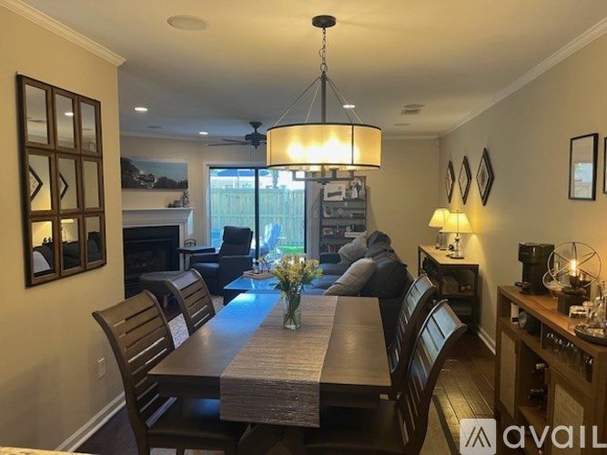 A dining room with a table and chairs.
