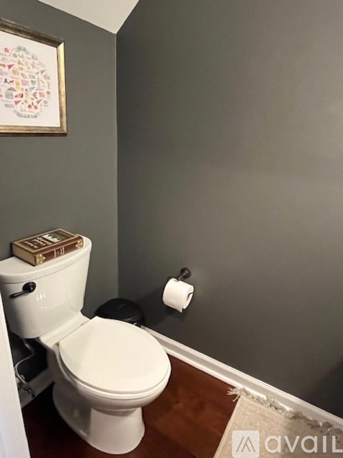 A white toilet with a book on top of it.