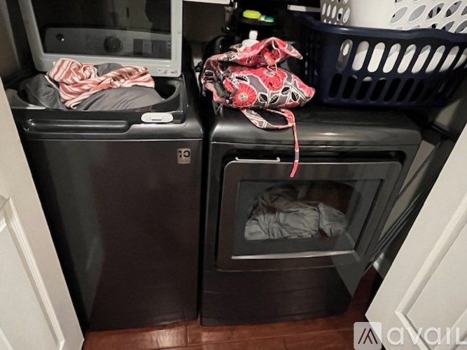 A black oven with the door open and a bag on top of it.